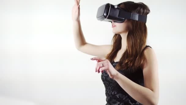 Wanita muda menggunakan kacamata virtual reality terisolasi pada latar belakang putih — Stok Video