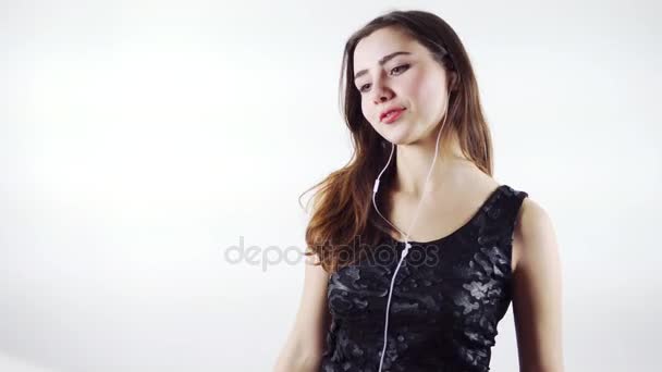 Happy Young Woman Listening to Music With Earphones And Dancing isolated on white background — Stock Video