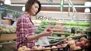 Güzel kadın Kırmızı elma süpermarkette alışveriş