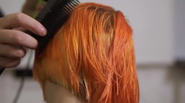 Portre profesyonel kuaför saç kesimi sonra saç kurutma makinesi kullanarak görünümünü. Güzellik Salonu genç Kızıl saçlı kadın. Slowmotion atış