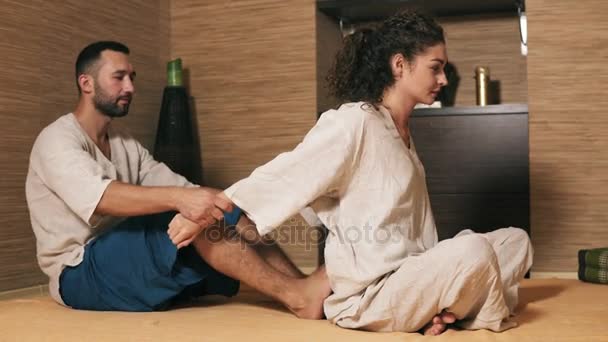 Traditional Thai Massage Cobra On Knee Position Young Man And Woman Dressed In Uniform Making Stretching Traditional Thai Massage Cobra On Knee Position Young Man And Woman Dressed In Uniform Making Stretching