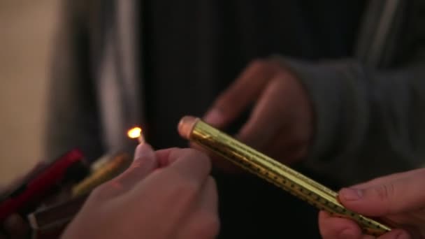 Closeup view of hands of friends holding sparkling candles and lightening them up — Stock Video