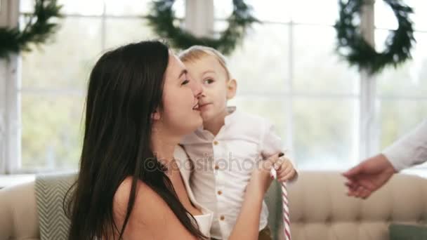 Blonde cute toddler on the couch with his parents. Family christmas party at home — Stock Video