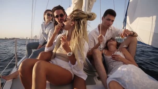 Young people relaxing on a yacht. Party on a yacht. Corporate party on a yacht. Young people having fun on a yacht. Walk on a yacht along the river. Cruise on a boat. Close up — Αρχείο Βίντεο