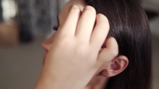 Make up artist gently put on base foundation on a models face using a spounge. Close up of models face with almost finished evening make up. Indoors professional make up studio — Stock Video