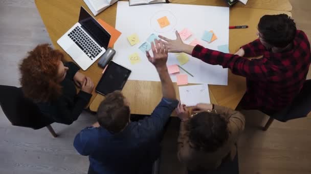 European happy team of business people students stack hands in pile together as teamwork and help, friendship concept, support in group work, unity trust cooperation. Footage from above. Slow motion — Stockvideo