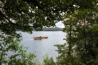 Wooden boat on Derwentwater Lake in the Lake District, England, UK clipart