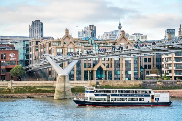 Дневной круизный лайнер, проходящий через мост тысячелетия. Лондон, Великобритания — стоковое фото