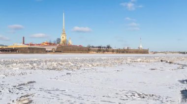 Kar ve buz kaplı doğal görünümü Peter ve Paul Fortress ve Neva Nehri. Kış güneşli bir gün, mavi gökyüzü bulutlu. Saint-Petersburg, Rusya. Zaman atlamalı.