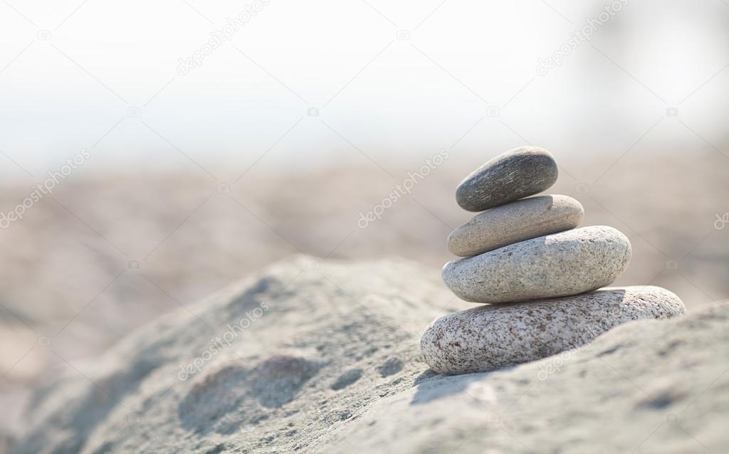 pile of white stones on the beach. Sea blurred background