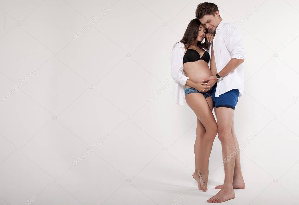 man touching the belly of a pregnant woman