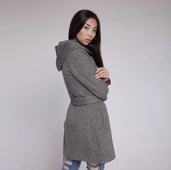 Asijská modelka v oblečení podzim/zima pózuje v světlé pozadí — Stock fotografie