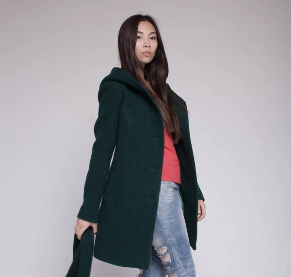 fashion asian model in autumn/winter clothes posing in light background