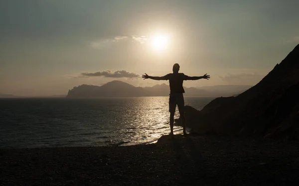 Silhouette of Man Raising His Hands or Open arms when sun rising up