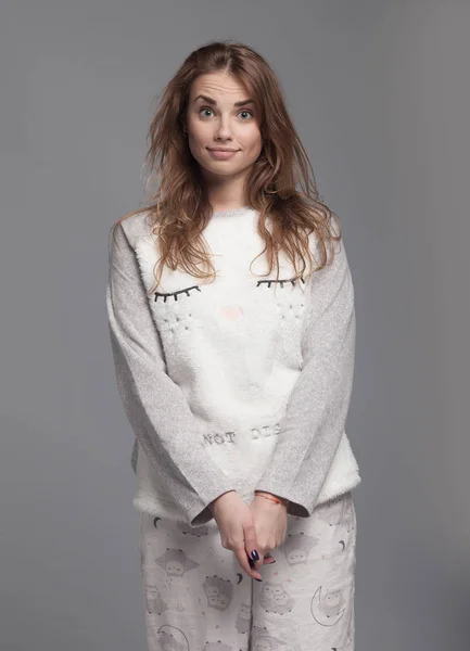 Happy teenage girl in funny pajamas on grey background studio. Funky teenager wearing Pajamas cartoon style