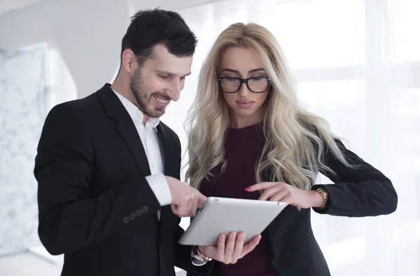 Young smiling business woman and business man meeting and talk in office