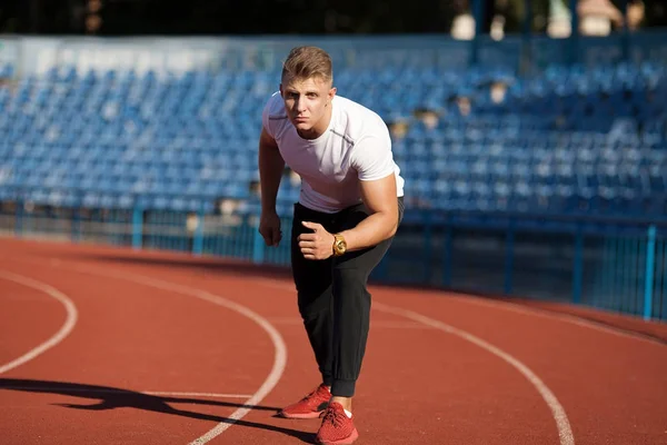 Man ready to start running on a track