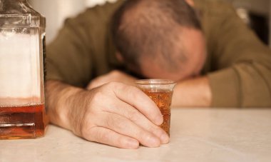 Masada Uyuyan adam alkol bağımlısı. Üzgün üzgün erkek yetişkin having zahmetli ile alkol.