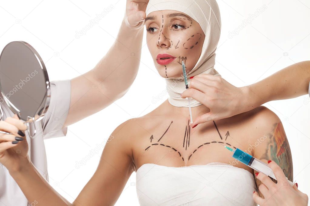 Amazing girl studio background and looking mirror , plastic surgery concept, doctor's hand on patient's face.