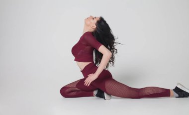 Sportif genç kadının gri arka plan - sağlıklı yaşam ve beden ve ruhsal gelişimi arasında doğal denge kavramı üzerinde izole yoga pratik yapması