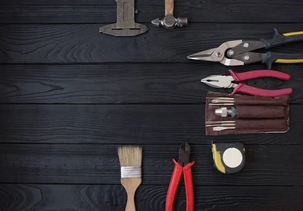 Close up tools on a wooden background