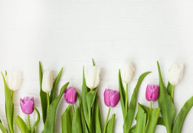 Beyaz ahşap zemin üzerinde renk laleler