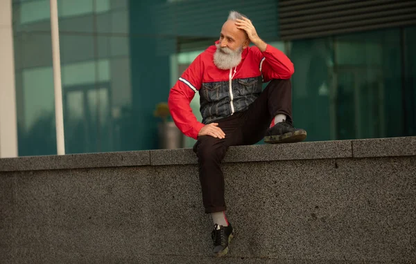 Portrait of mature bearded active man  walking in a city