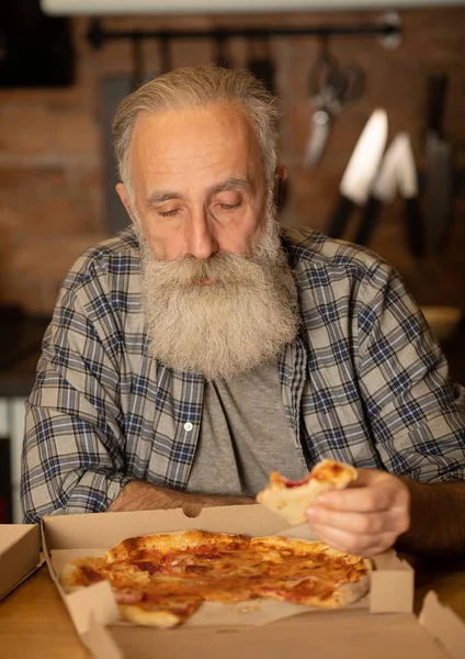 Smiling Older Man Eating Pizza Slice Sitting Living Room Bearded — Stock Photo, Image