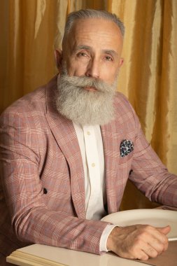 Lüks içinde iyi giyimli, sakallı kıdemli bir adam..