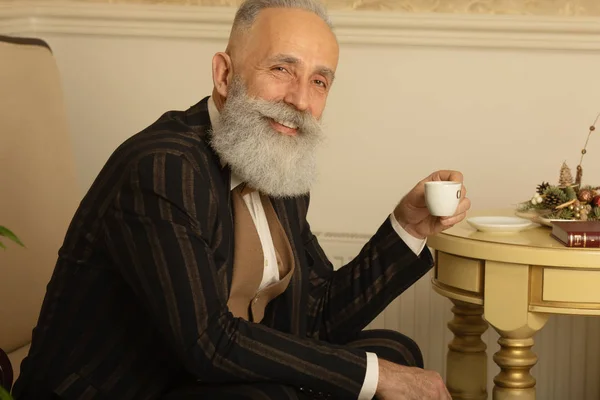 Senior Handsome Concentrated Man Beard Business Suit Sitting Drinking Coffee — 스톡 사진