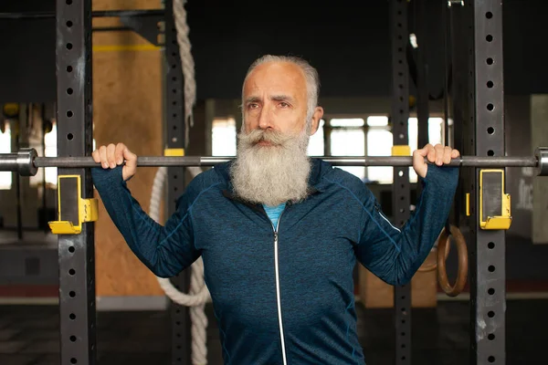 Serious bearded senior male is enjoying sporty lifestyle