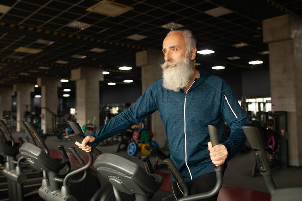 Senior Man On Running Machine In Gym