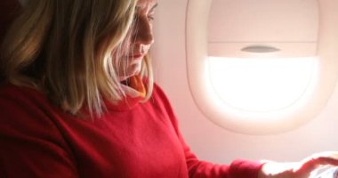 blonde woman using digital tablet