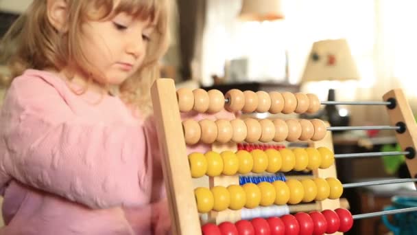 Cute little girl playing with abacus — Stock Video