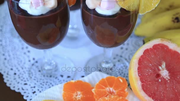 Chocolate pudding with whipped cream and fruits — Stock Video