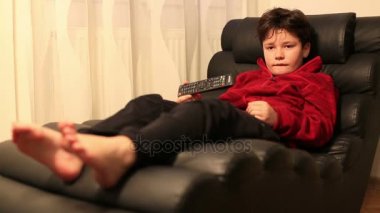 Çocuk 2 kanepede yatan uzaktan kumanda ile