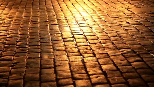 People walking in a cobblestone street at night 5 — Stock Video