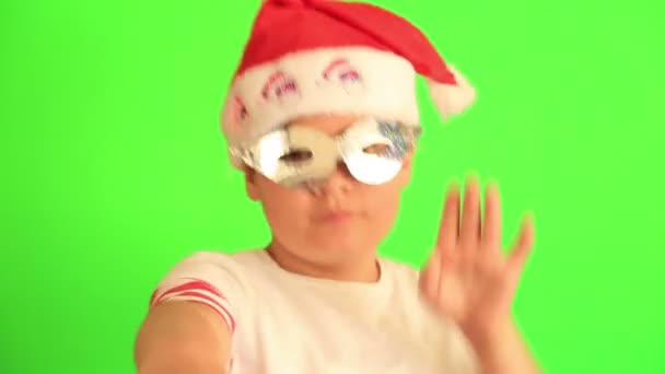 Happy child wearing santa hat dancing — Stock Video