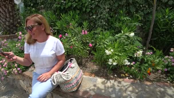 Vrouw met behulp van slimme telefoon op de outdoor — Stockvideo