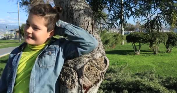 Giovane ragazzo rilassante sotto la luce del sole al parco 2 — Video Stock