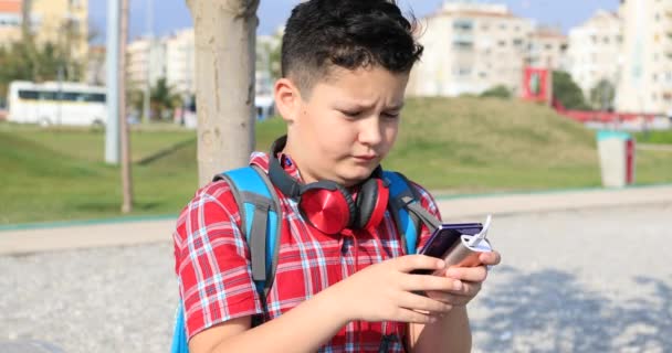 Menino Escola Usando Smartphone Relaxando Parque Cidade — Vídeo de Stock