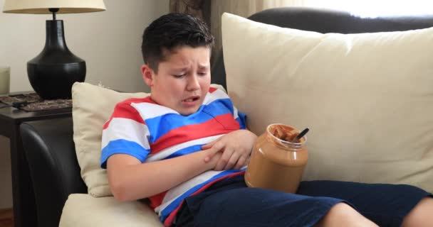 Painful Preteen Boy Having Abdominal Pain Eating Too Much Peanut — Stock Video