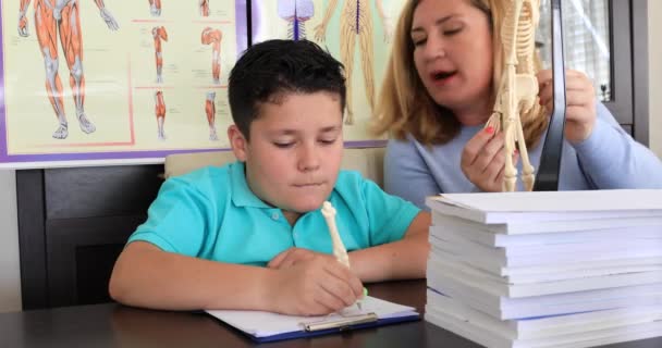 Teacher Helping Young Boy Biology Lesson — Stock Video