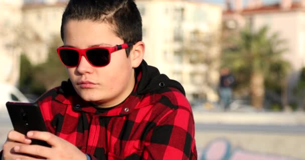 Portrait Handsome Teen Boy Sitting Skate Park Alone Kid Watching — Stock Video