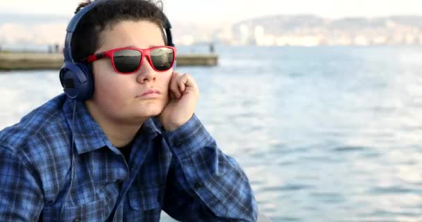 Portrait Young Handsome Sad Teenage Boy Headphone Looking Camera Outdoor — Stock Video