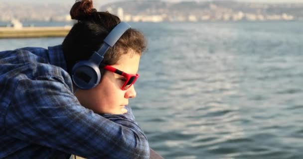 Portrait Handsome Sad Teenage Boy Headphone Looking Camera Seaside — Stok video