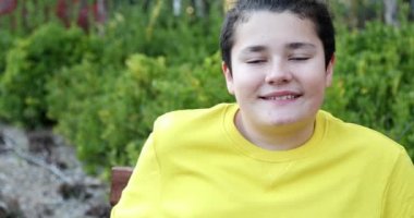 Portrait Of A Happy Teenage Boy Looking To Camera And Smiling At The Nature