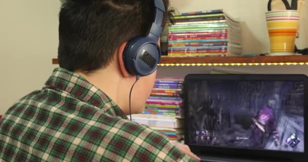 Teenage Gamer Playing Computer Game Looking Camera Smiling — стоковое видео