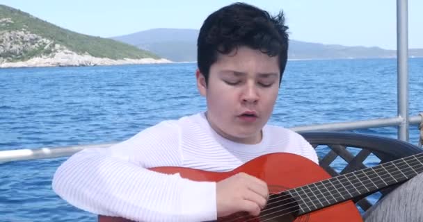 Ung Pojke Musiker Yacht Däck Öva Med Gitarr När Reser — Stockvideo