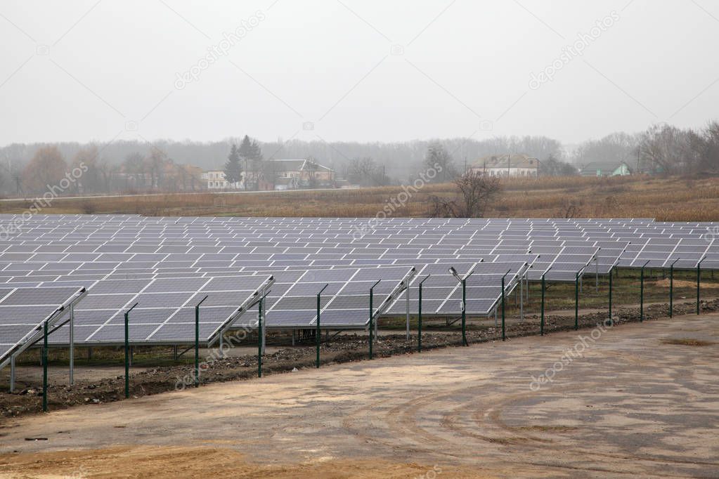 Solar panels near a rural road. Installation of solar panels in rural areas.